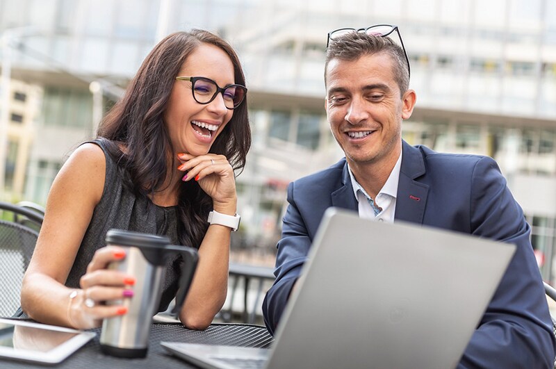 Office Colleagues Sitting with a Coffee Outside