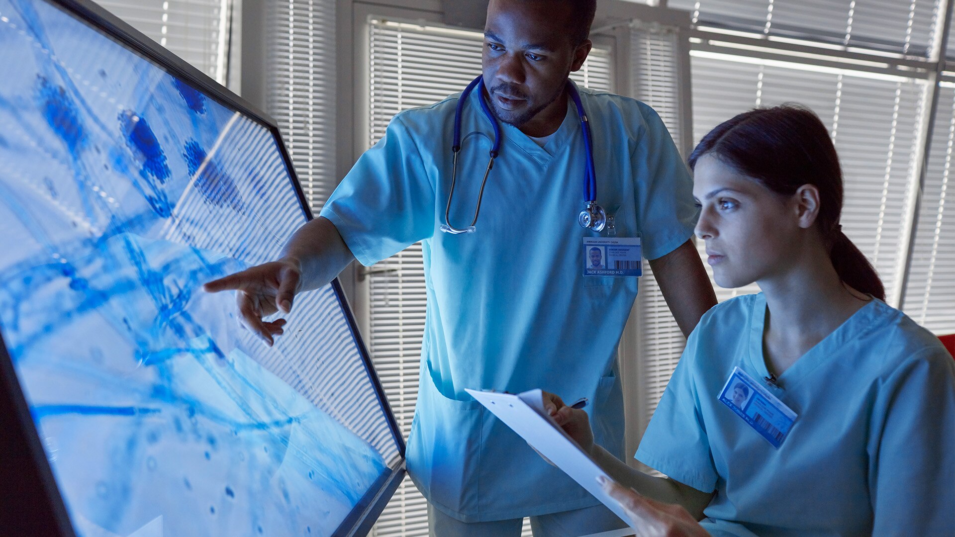 Health Care Professionals Evaluating a Magnified Microscopic Image on a Computer Monitor