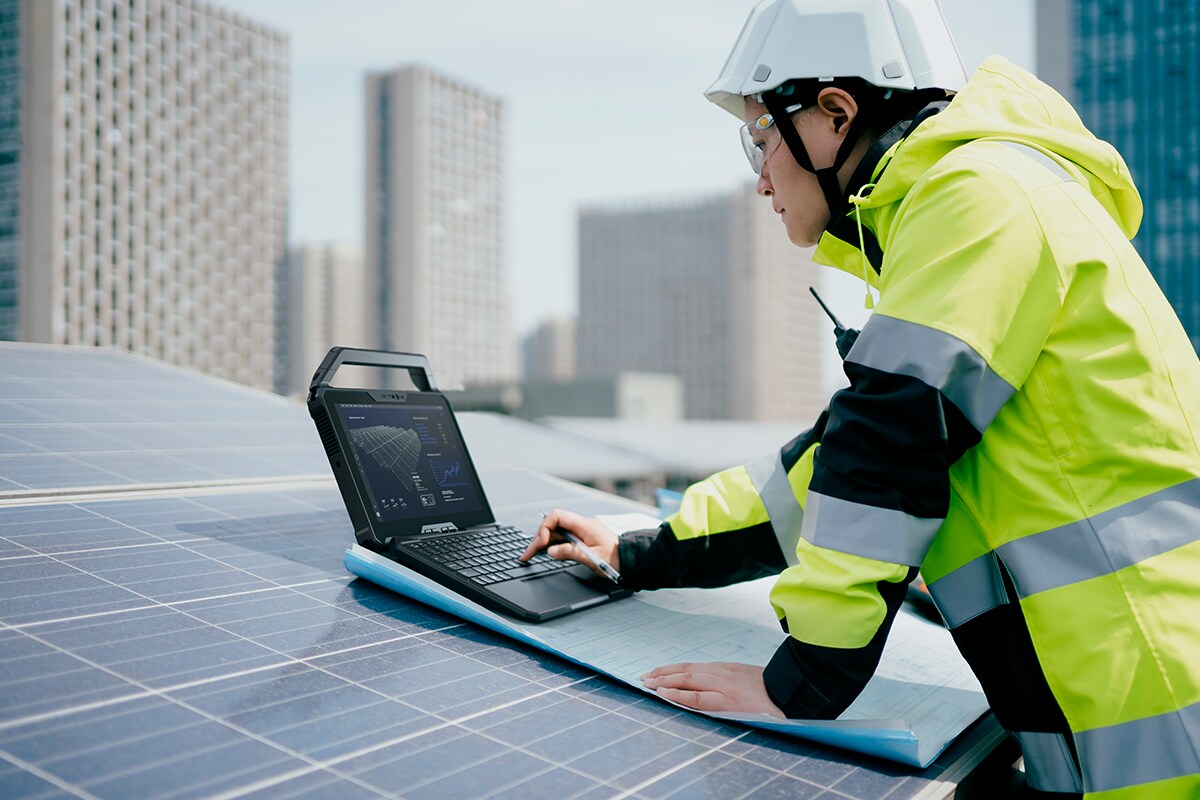 Engineer with solar panels and Lati Rugged 7030 
