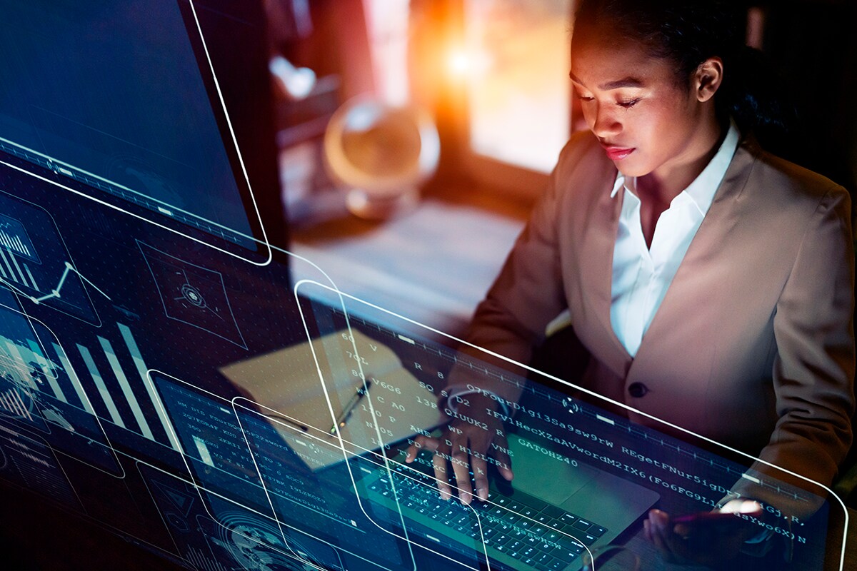 Woman at Computer with Screen Data Projected