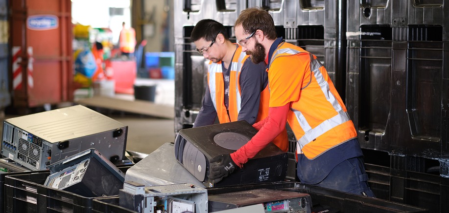 Desktop computer systems being unpacked at a recycling facility