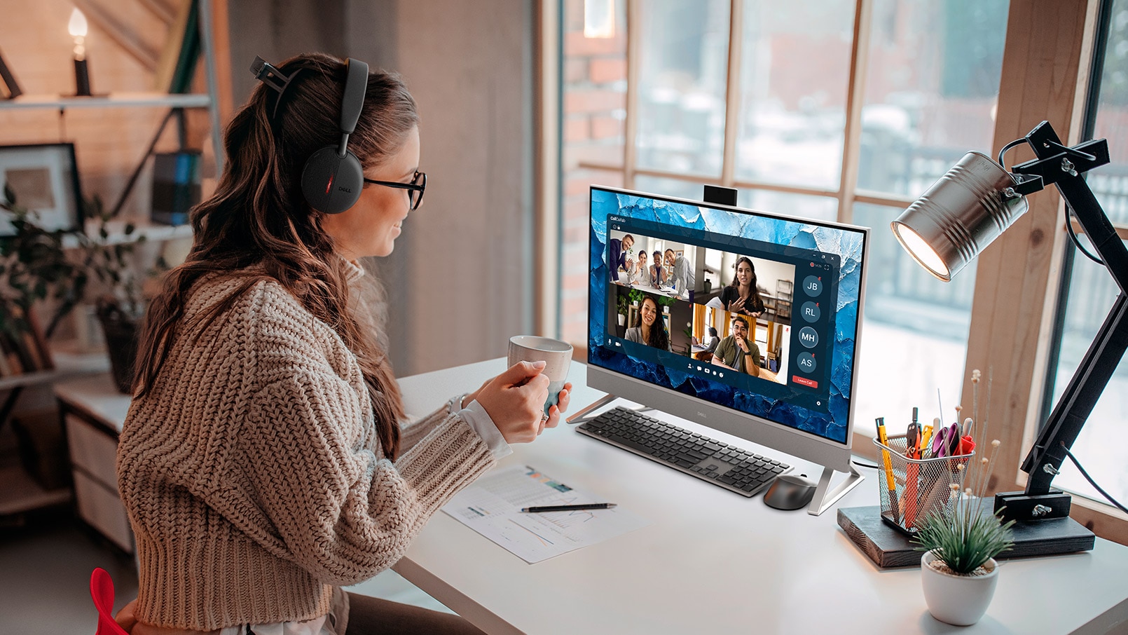 Business woman having a video call with coworkers cozy at home using Dell 27 inch EC27250 non touch computer, Screenfills and UI containing Dell Tech