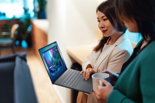 TWo women looking at a Dell Pro Max 14 premium laptop