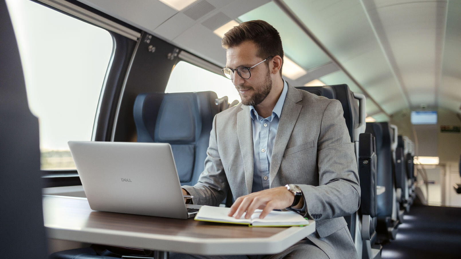 Businessman Using Dell Pro 16 PC16255 non touch laptop, code name Jade Delta While traveling with high speed train.