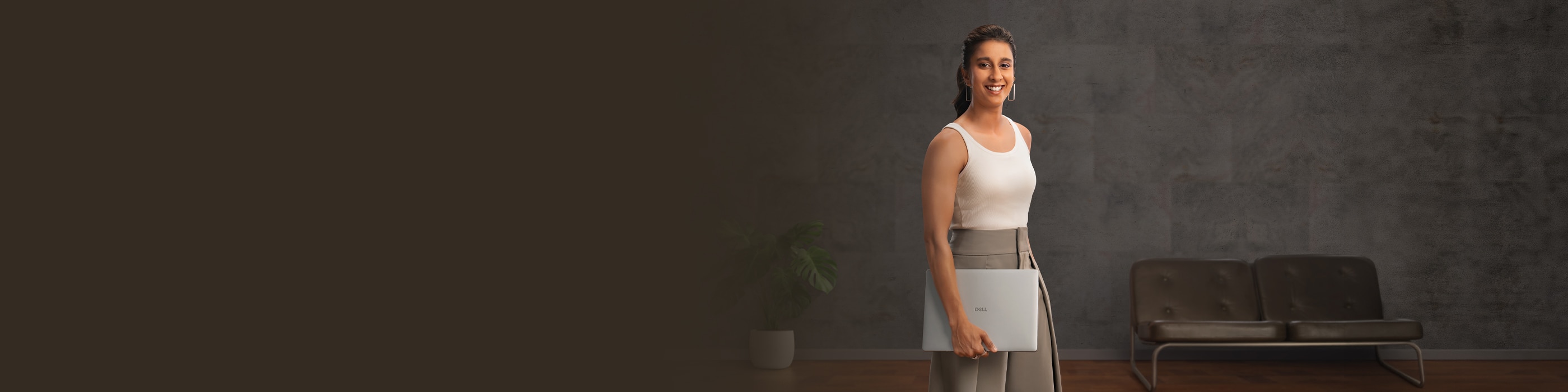 Banner featuring a woman smiling and carrying her dell laptop with her