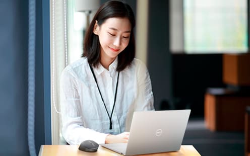 Young Japanese woman happily working.