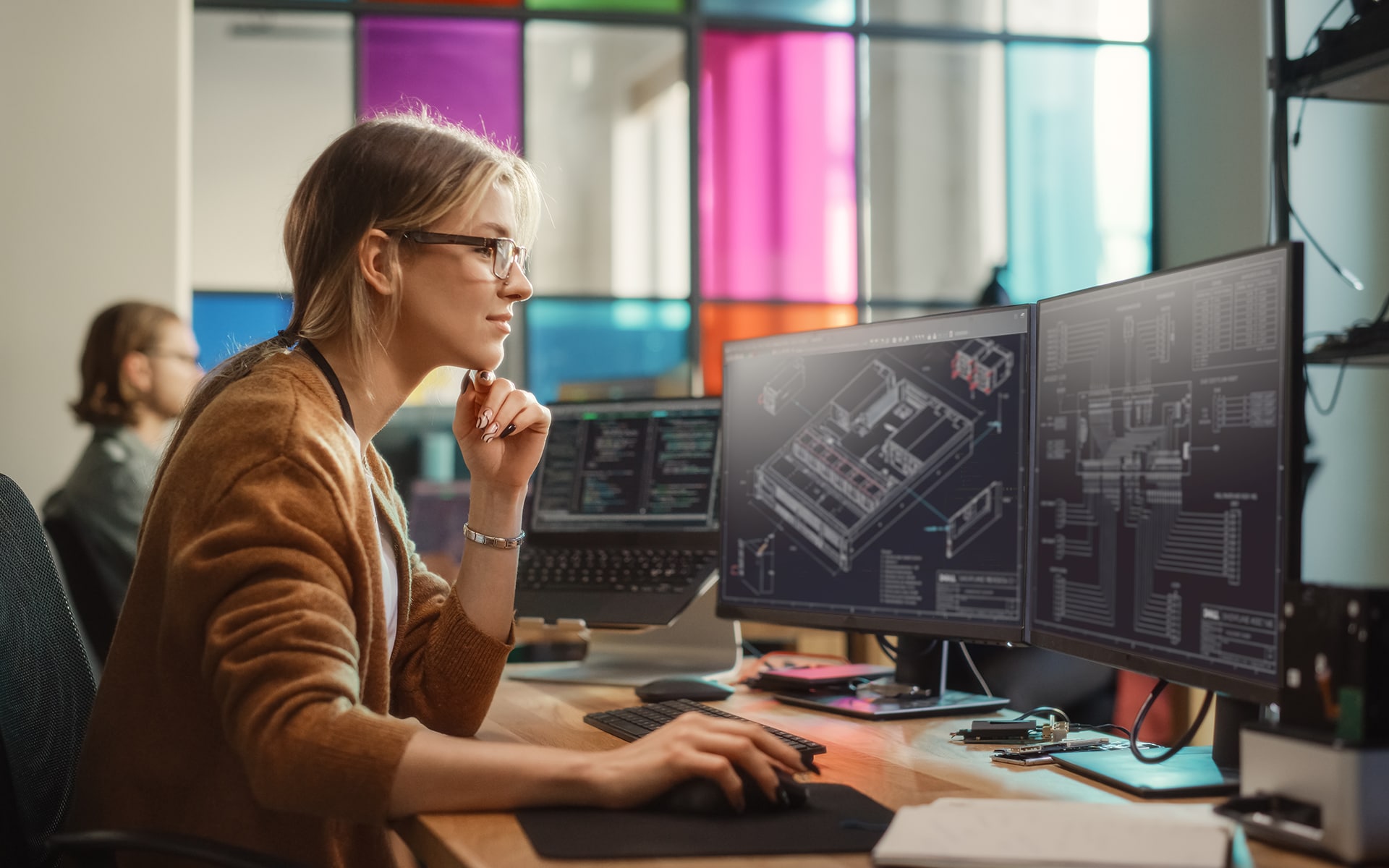 Female Software Engineer Writing Code on Desktop Computer with Multiple Screens Setup in Coworking Office Space. Professional Caucasian Woman