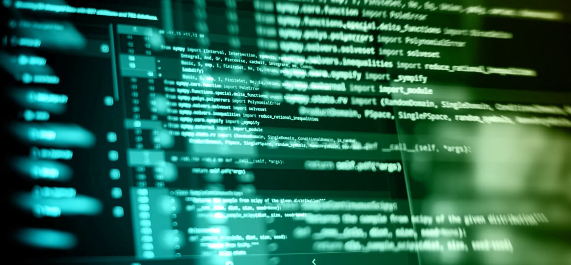Close-up of abstract glowing teal and green computer code illuminated on a dark digital screen background.