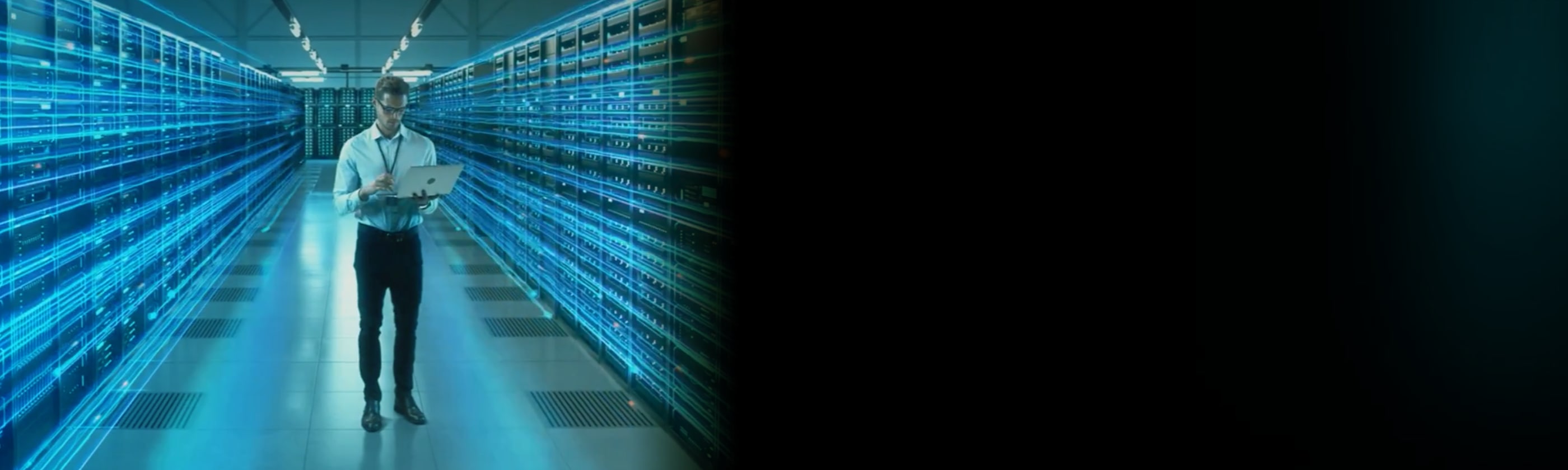 IT professional using a laptop in a data center aisle, with glowing blue digital lines overlaying the server racks.