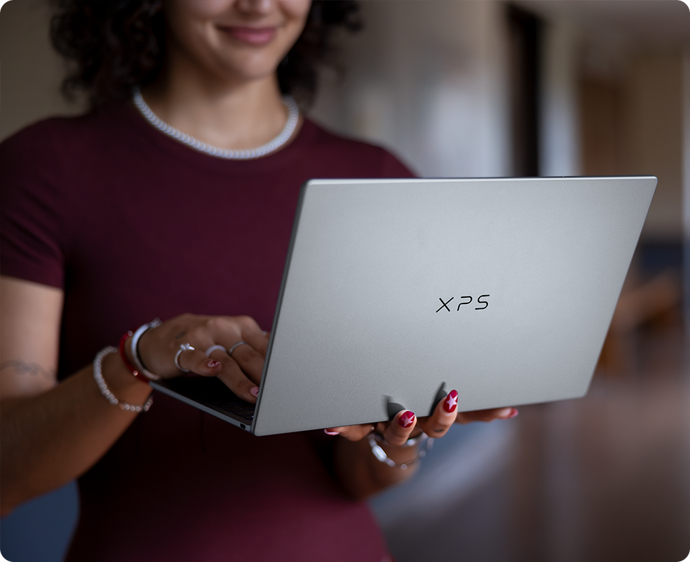 Student Holding Laptop In Hallway