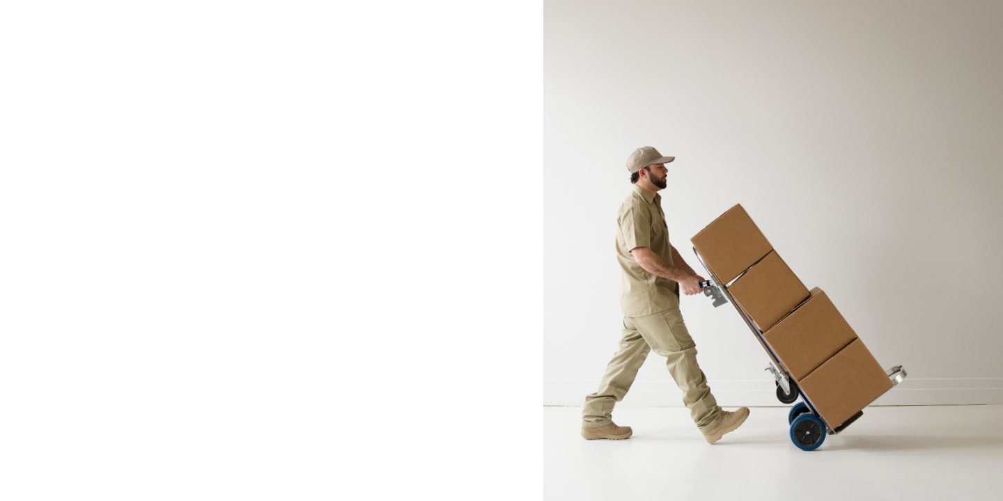 Delivery Man Pushing Handcart with Boxes.