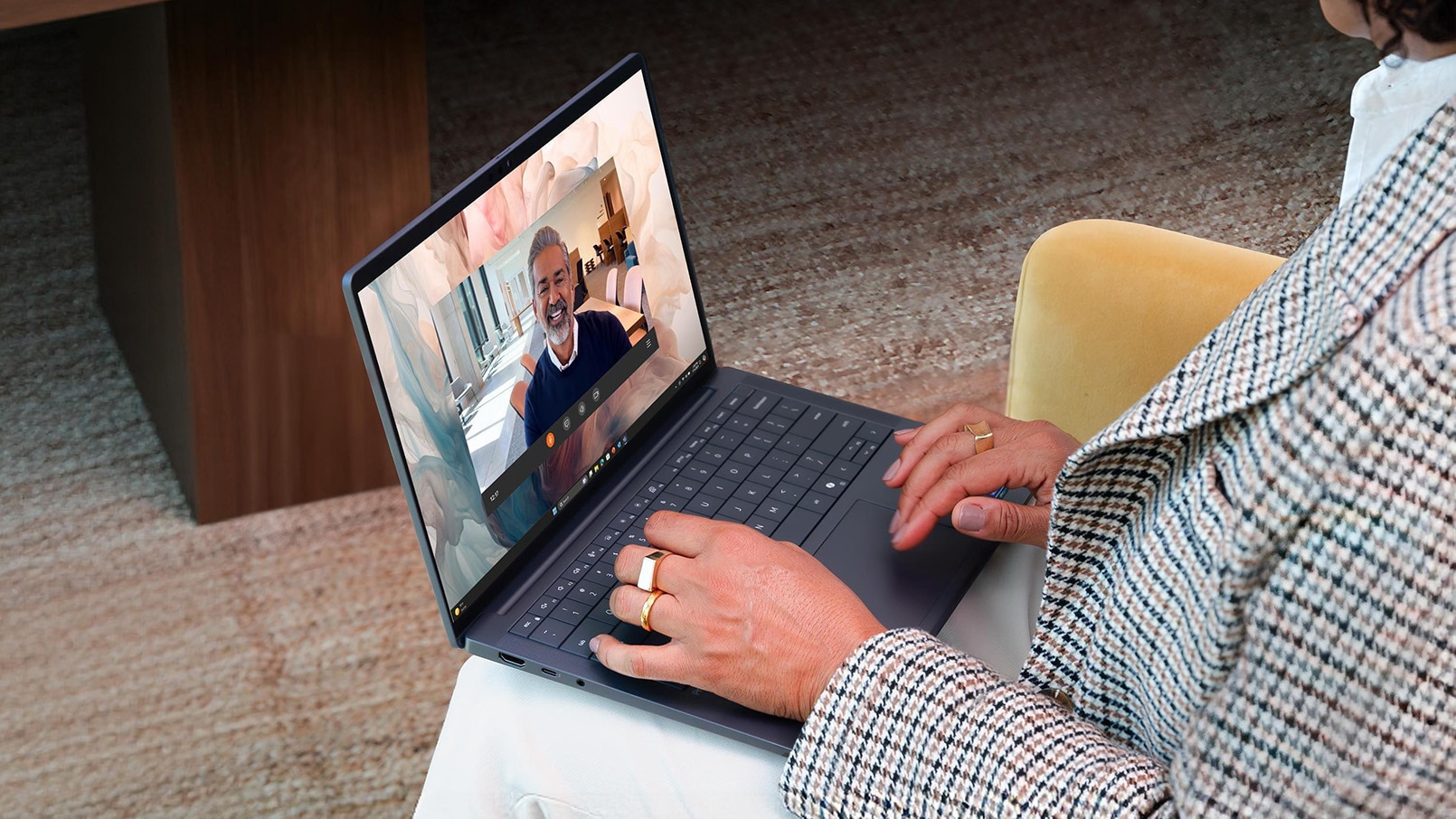 An over the shoulder view of a CEO working in an office setting away from her desk.