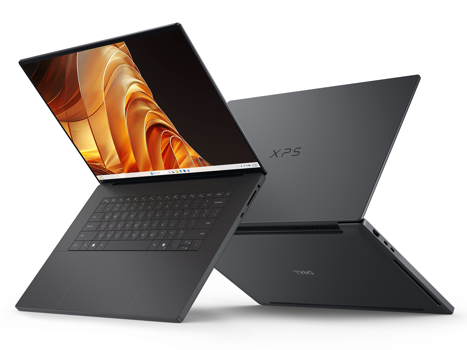 Two dark gray Dell XPS 16 Creator Edition laptops, one open with an orange screen graphic and one partially closed showing the XPS logo on the lid
