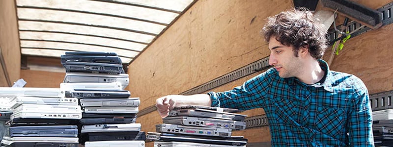 Man back of truck with computers to be recycled