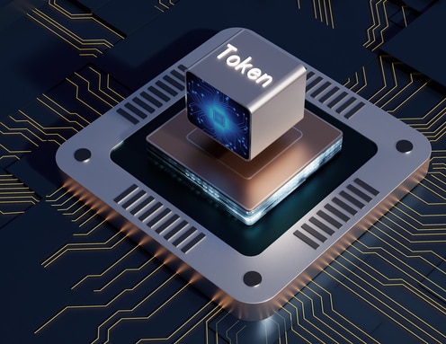 Silver Token cube resting on a computer processor with glowing gold circuits on a dark motherboard.