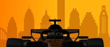 A McLaren Formula 1 car against the Austin skyline