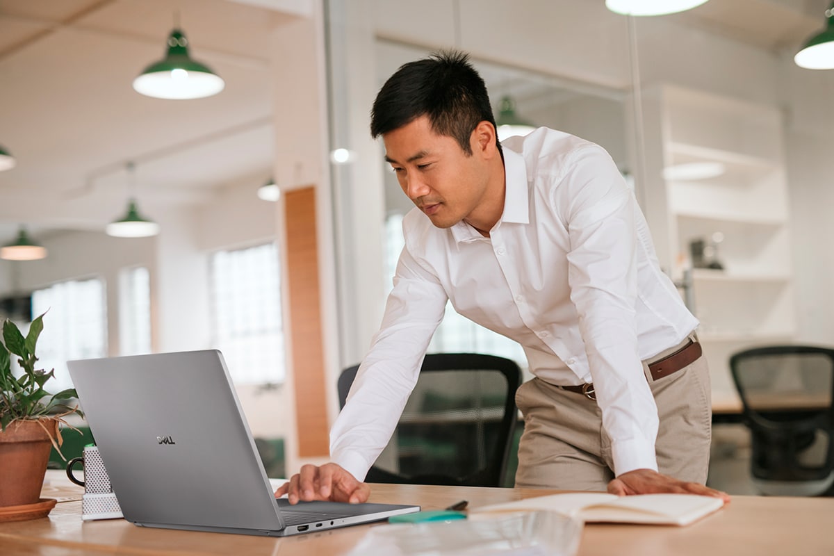 Man working on laptop in modern office