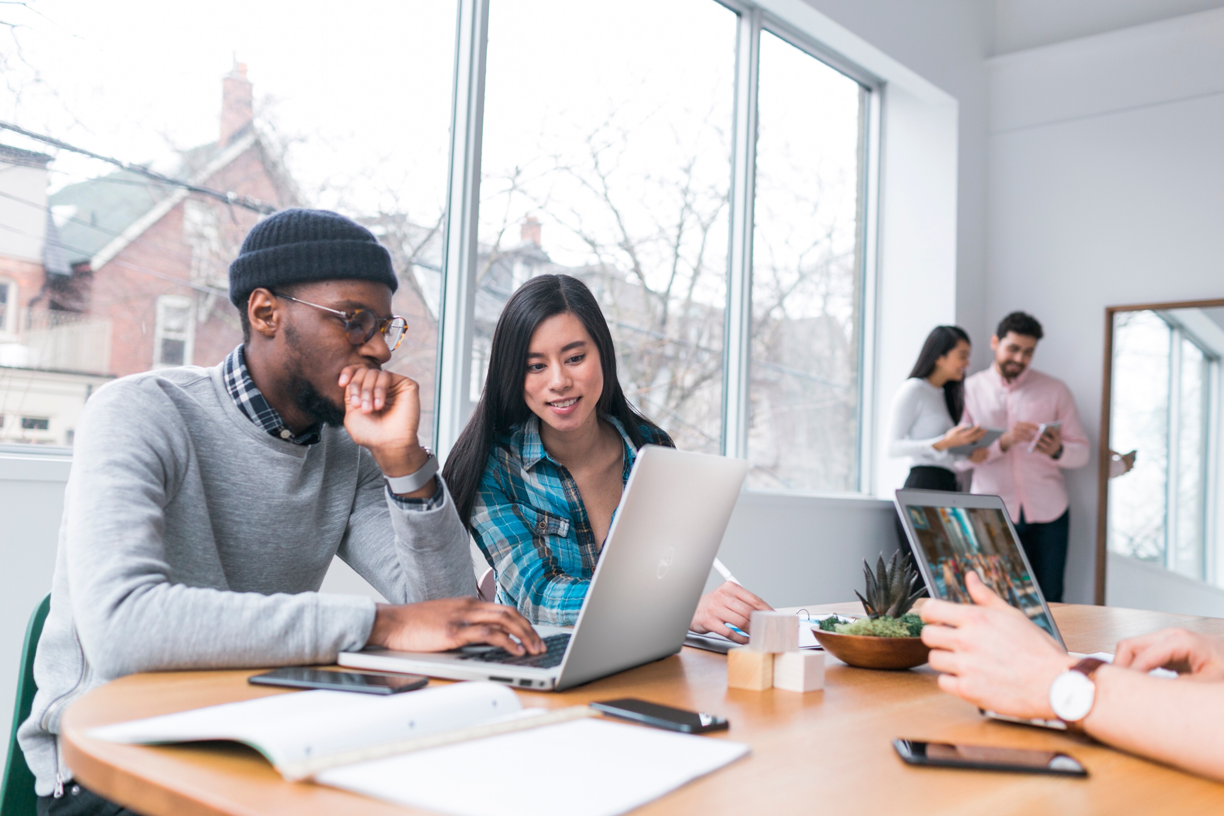 Young Professionals Working on Laptops in an Office