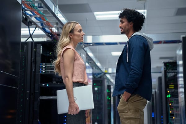 IT Professionals Having a Conversation in a Data Center