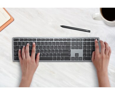 Picture of hands typing on a Dell Multi-Device Wireless Keyboard KB700.
