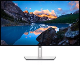 Imagen de un monitor Dell UltraSharp U3223QE con un panorama natural de fondo.