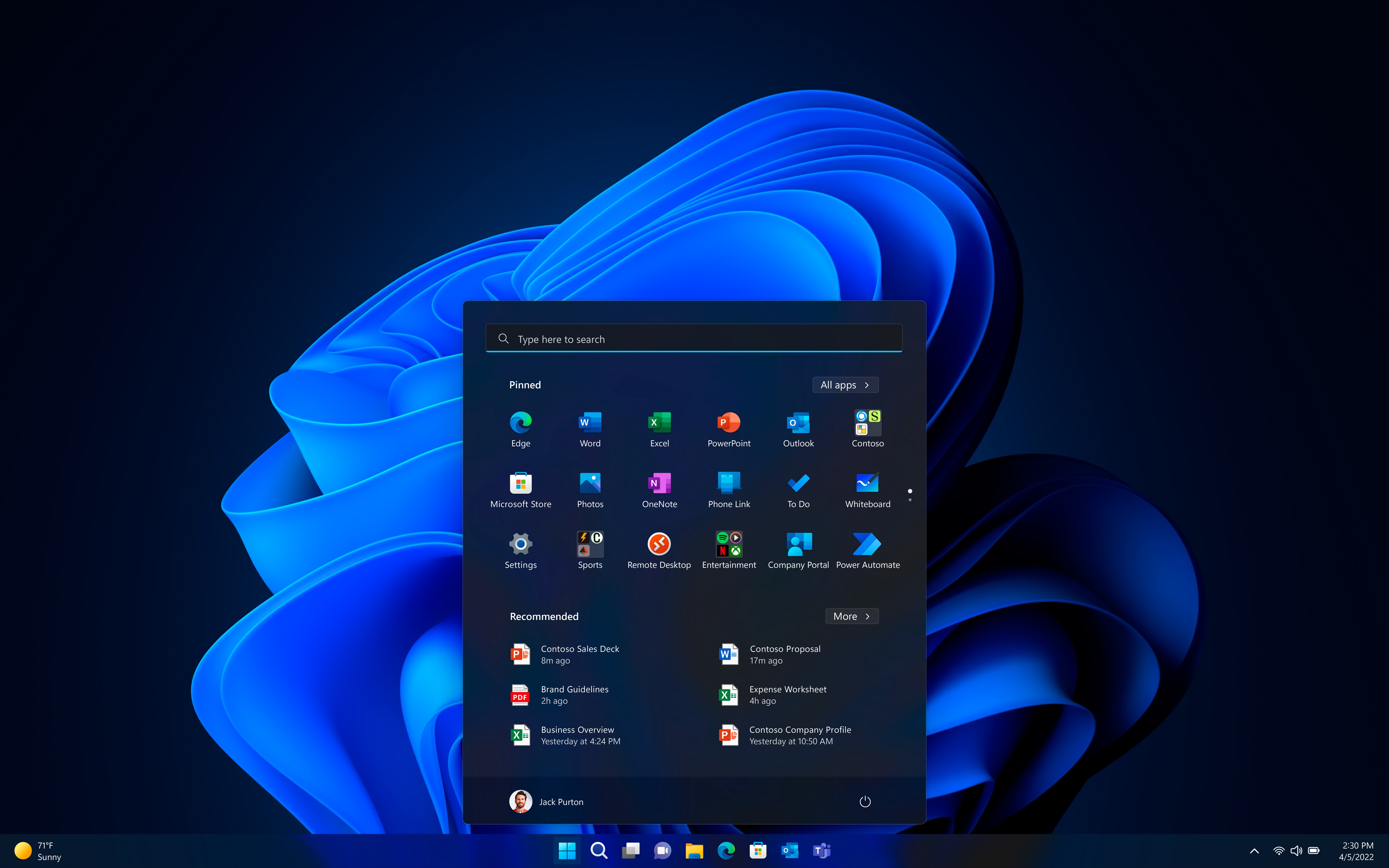 Laptop homepage with Microsoft Windows 11 blue logo as background and search tool opened.