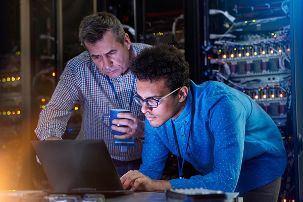 IT Techs Working in a Dark Server Room
