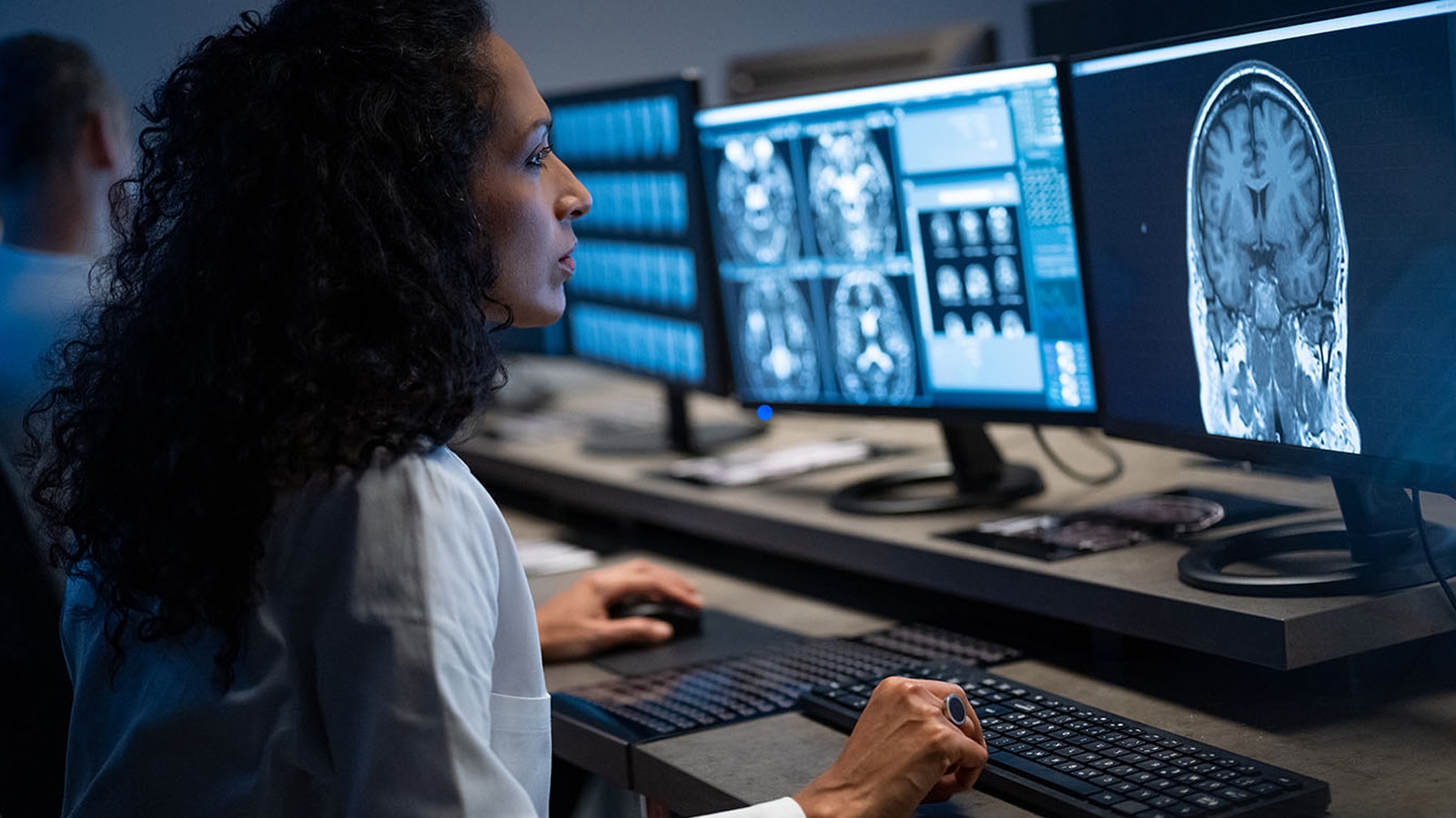 Female radiologist analysing the MRI image of the head.