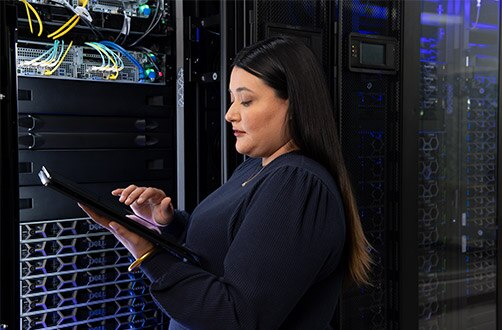 Young Woman Working On Servers In Data Center