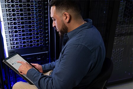 Young Man Working From Server Room