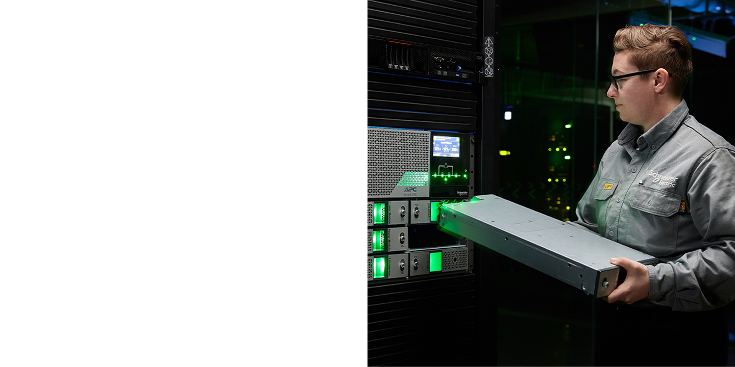 image of a woman putting an APC rack inside an enclosure