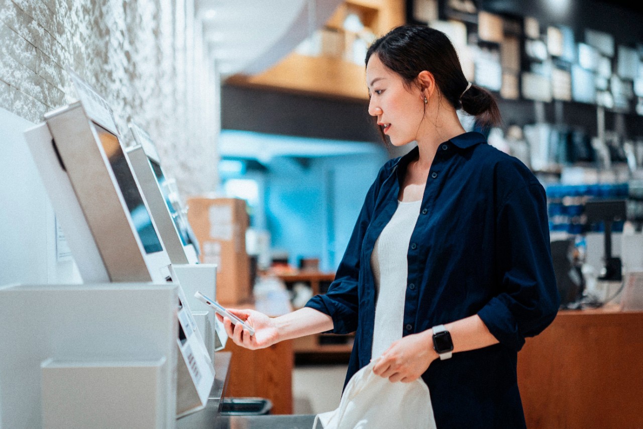 Woman Using a Self-Checkout in a Store