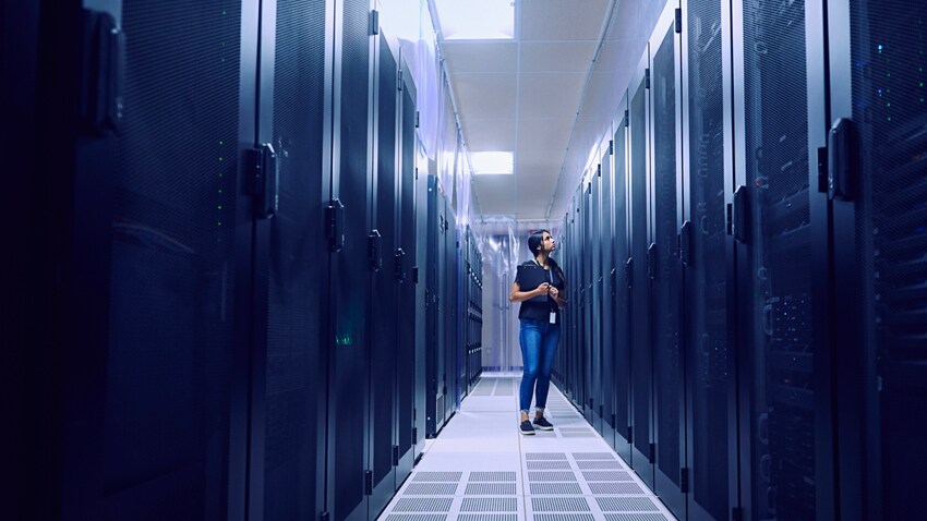 Woman in Data Center Hallway
