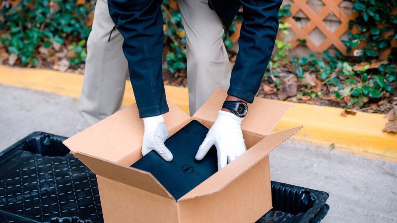 Asset Recovery Services - Man Packing Laptop Into Box