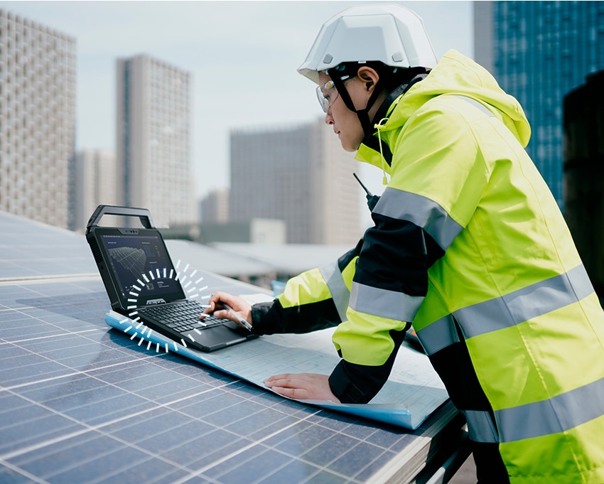 Engineer with solar panels and Lati Rugged 7030 