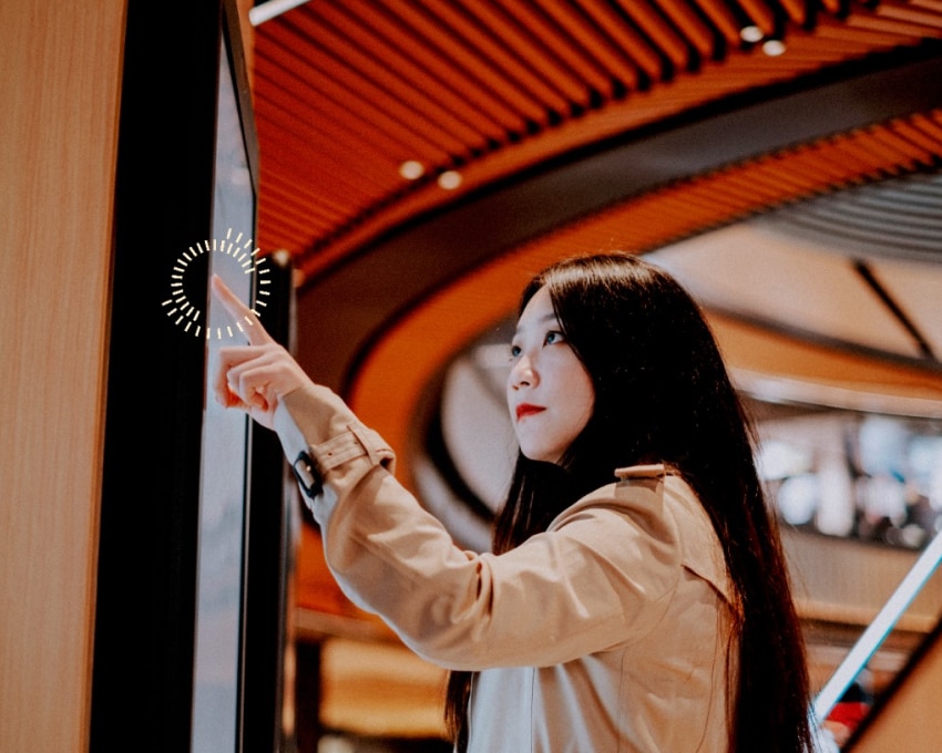Woman Interacting with an AI Screen in the Mall