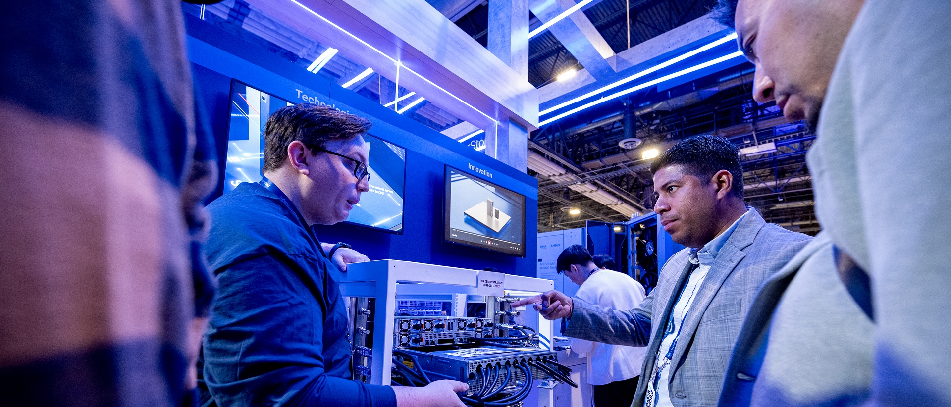 Two conference attendees seeing server cooling up close at a demo