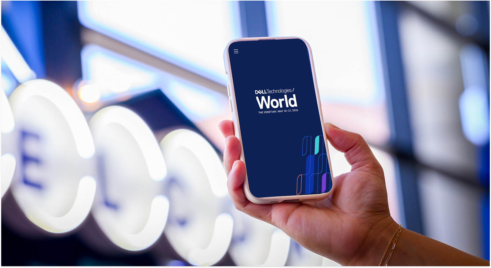 Photo of a hand holding a mobile device showing the splash screen of the DTW mobile app