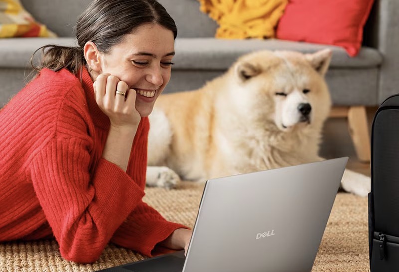 Smiling Woman Working by Dog at Home