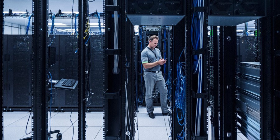 Technician Person in the Server Room with Mobile