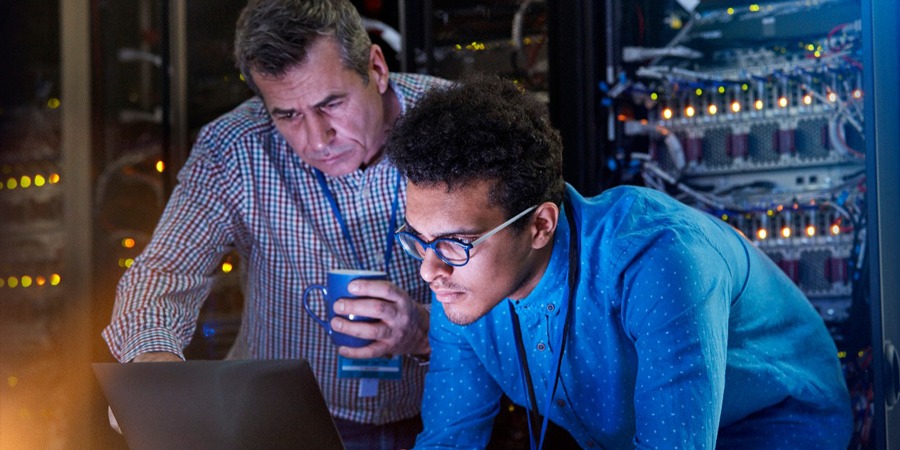 IT Techs Working in a Dark Server Room