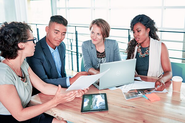 Team of Successful Business People Having a Meeting in Executive Sunlit Office