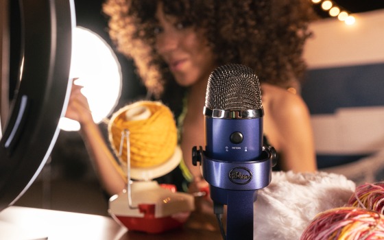 Woman recording a video using a Logitech Yeti Nano microphone