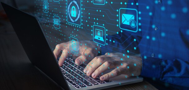 A person typing on a laptop with virtual AI visuals.