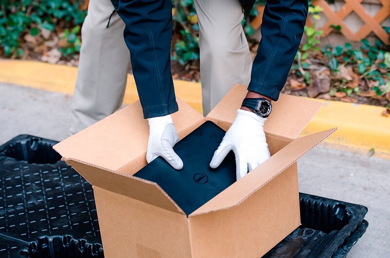Asset Recovery Services - Man Packing Laptop Into Box