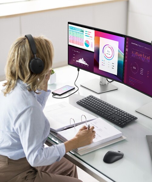 Woman working on P2425HE 24-inch P Series Monitors