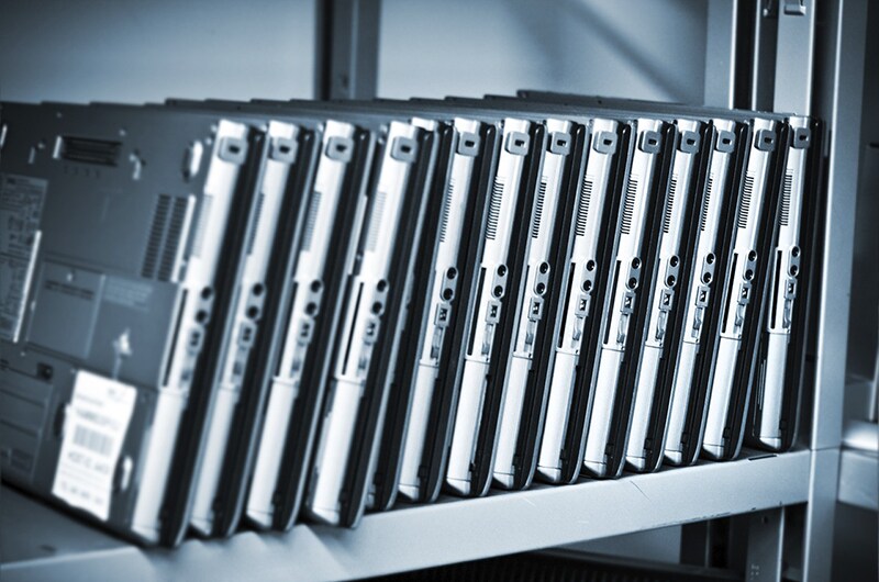 Old laptops in a row in workshop shelf