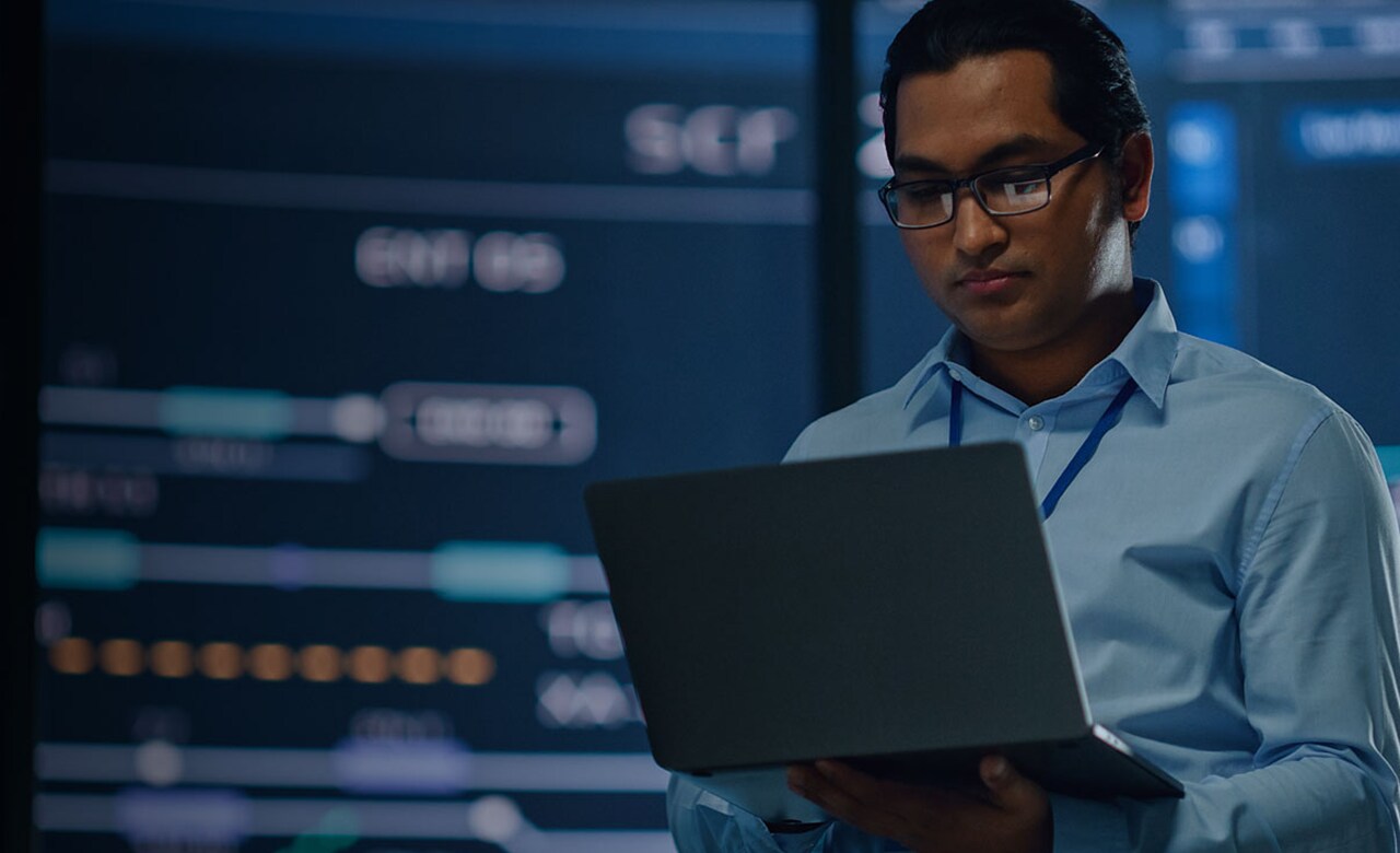 Man with laptop in data center