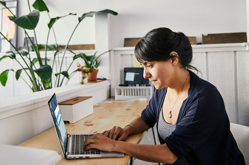 Professional focused on a laptop in creative space