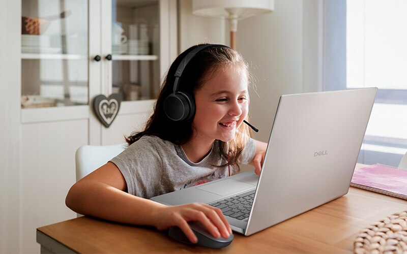 Little Girl Using Laptop at Home